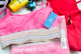 cupshe swimsuits near sunglasses and sunscreen
