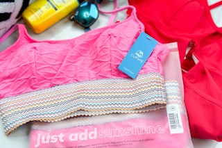 cupshe swimsuits near sunglasses and sunscreen
