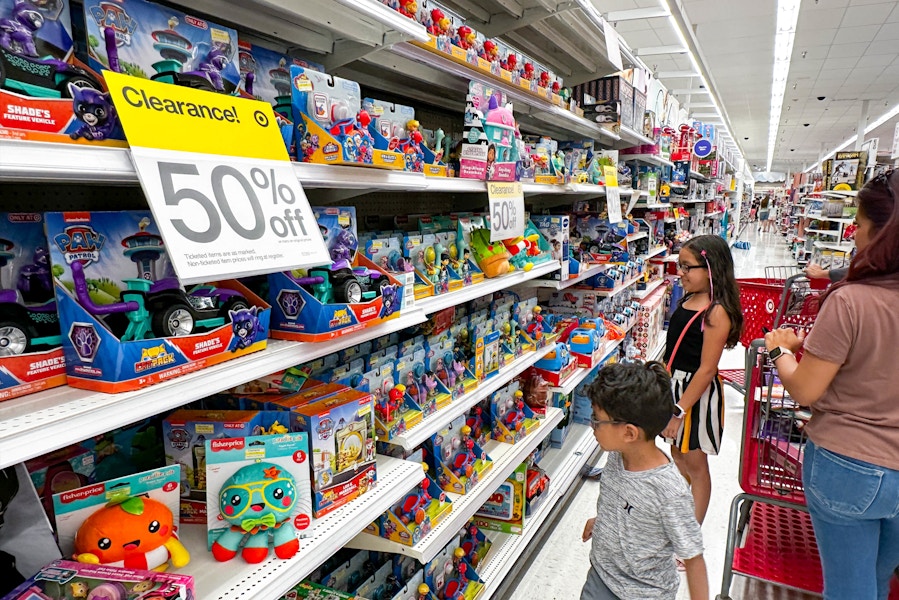 a mother and two kids shopping target toy clearance aisles