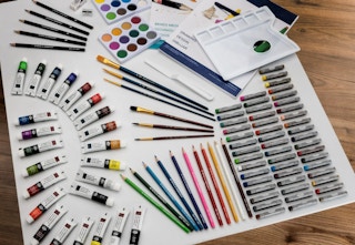 art set with paints, brushes, penciles, and crayons