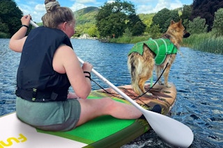 women on a paddle board with her dog
