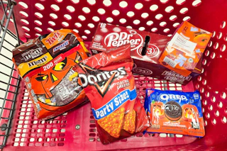 halloween candy, doritos, dr pepper, coffee, and oreos in a cart