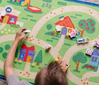a kid playing on an activity mat