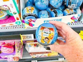 hand holding marvel doorables in walmart toy aisle