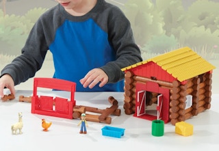 child playing with a Lincoln Log set
