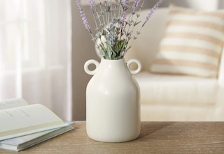white ceramic vase with lilacs in it