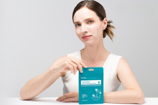 a woman holding a pack of Advanced Anti Wrinkle Patches