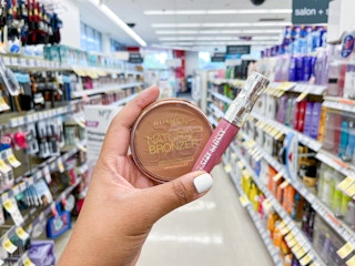 hand holding rimmel products