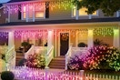 SmartDawn Smart Icicle Lights for Outside on a house lit up at night.