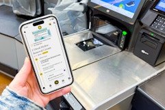 hand holding smartphone next to cash register with a kcl app 1-clip deal on the phone