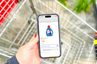 hand holding a smartphone displaying a 1-clip coupon in the kcl app