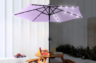 Lifestyle image of a lavender patio umbrella with LED lights shown in daytime and nighttime