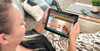 a woman looking at Hallmarks Countdown to Christmas webpage on an iPad