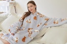 a woman wearing a cat blanket hoodie