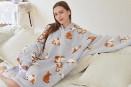 a woman wearing a cat blanket hoodie