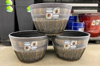 Three Better Homes & Gardens Whiskey Barrel Planters stacked on top of one another at Walmart