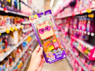 hand holding polly pocket cutie bear playset in walmart toy aisle