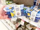 hand holding an ello lunch stack set in front of a target shelf