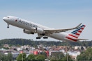 American airlines airplane taking off from an airport runway.