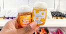 someone holding up some fall scented pocketbac hand sanitizers from Bath & Body Works