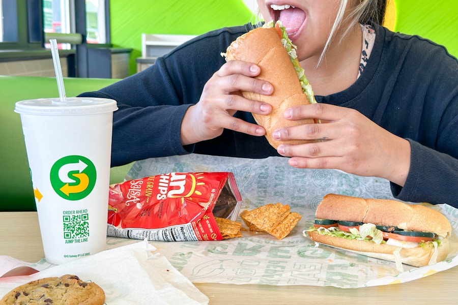 a person eating a subway sandwich 