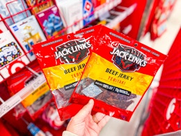 hand holding 2 jack links beef jerky bags at target