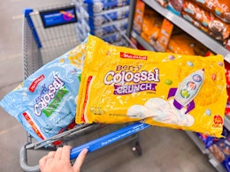 hand pushing cart with two bags of malt o meal cereal in walmart aisle