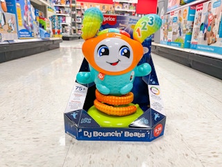 A DJ Bouncing Beats toy sitting in the middle of a store aisle.