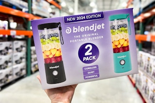 person holding a 2-pack of blendjet portable blenders in an aisle