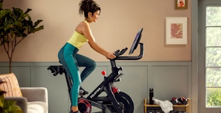 person exercising on peloton bike plus at home