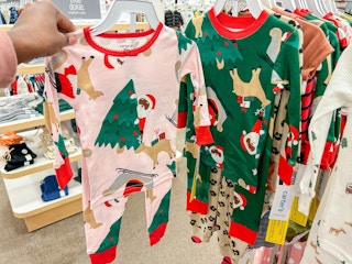 carter's christmas jammies hanging on a rack