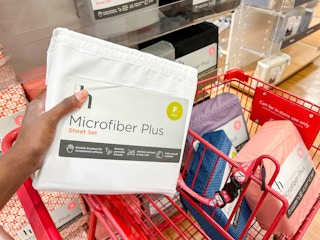 someone holding a microfiber sheet set