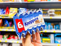 hand holding 6-count of Knoppers candy
