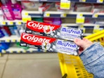 hand holding colgate maxfresh toothpastes