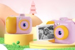 pink and yellow instant camera