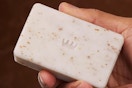 close up of man holding Cremo body bar 