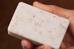 close up of man holding Cremo body bar 