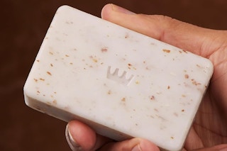 close up of man holding Cremo body bar