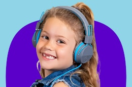 Stock image of a child wearing a blue pair of Jlab wired headphones