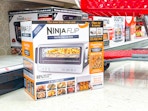 ninja flip air fryer toaster oven sitting in front of a target shelf