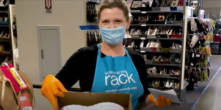 Nordstrom Rack employee wearing a face mask and gloves