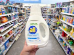 hand holding all free and clear laundry detergent in walgreens