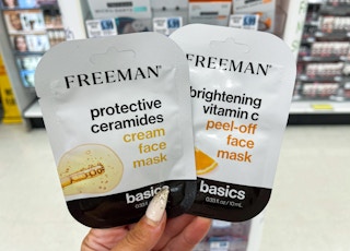 hand holding two freeman face masks