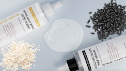two bottles of facial serum next to piles of rice