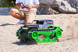 Lifestyle image of the Monster Jam Grave Digger Truck being played out in the dirt outdoors
