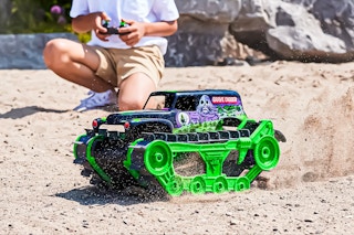 Lifestyle image of the Monster Jam Grave Digger Truck being played out in the dirt outdoors