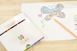 A drawing next to coloring pencils