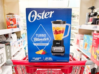 oster blender sitting on top a target cart