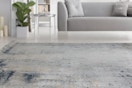A rug that's supposed to be 3 x 5 feet is on the floor in front of a grey sofa. This is the only pic that didn't look like an 8 x 10.