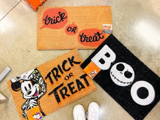 Three Halloween doormats on the ground